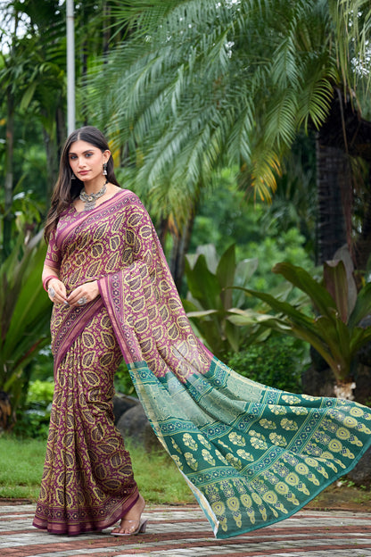 Woman in walking pose wearing mauve purple leaf print cotton saree with teal border — Chandrikas