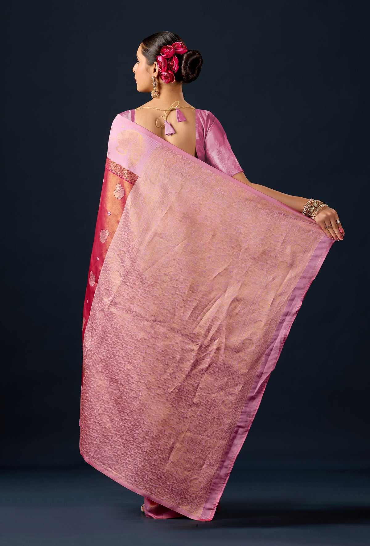 Woman draping metallic rust pink silk matka motif border saree showing pallu design — Chandrikas