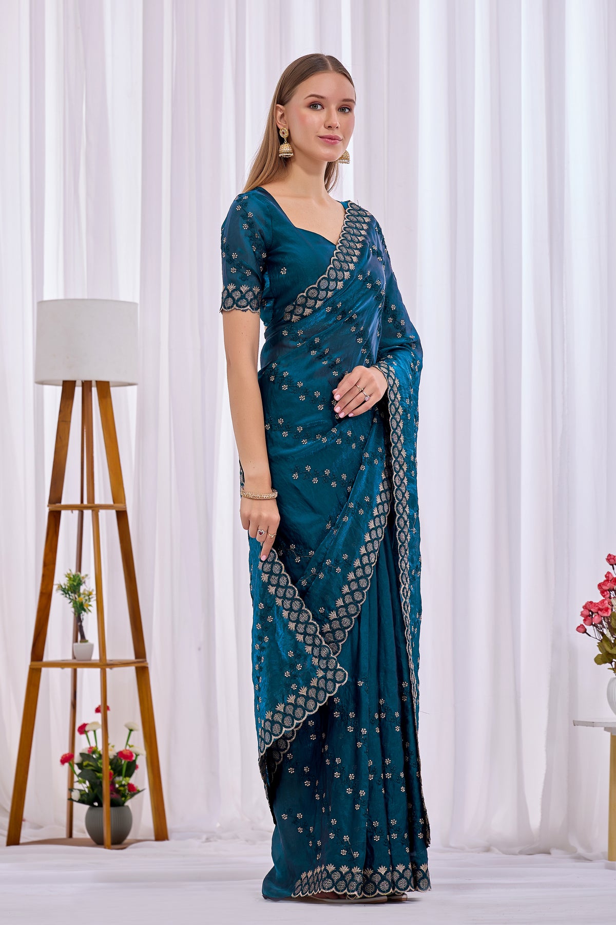Side pose showing pleats and border of Mor Peach satin floral thread work designer border saree — Chandrikas