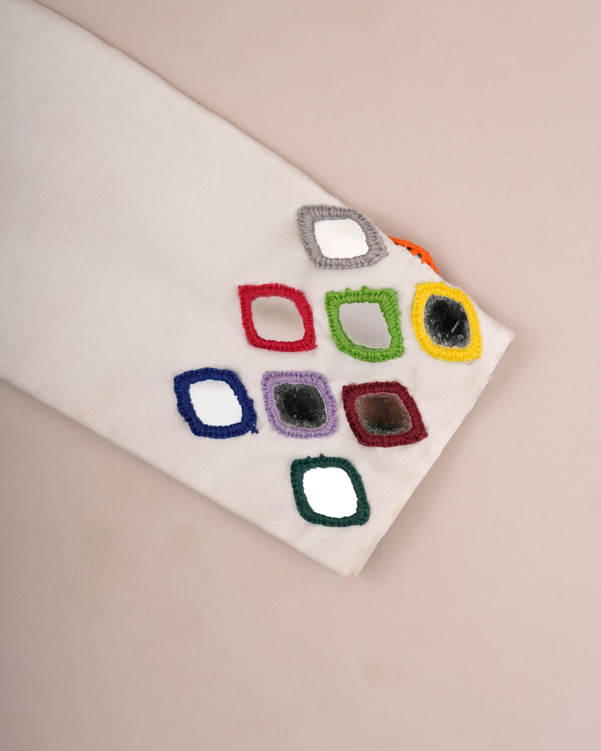 Close-up of multi color mirror work embroidery on blouse sleeve — Chandrikas