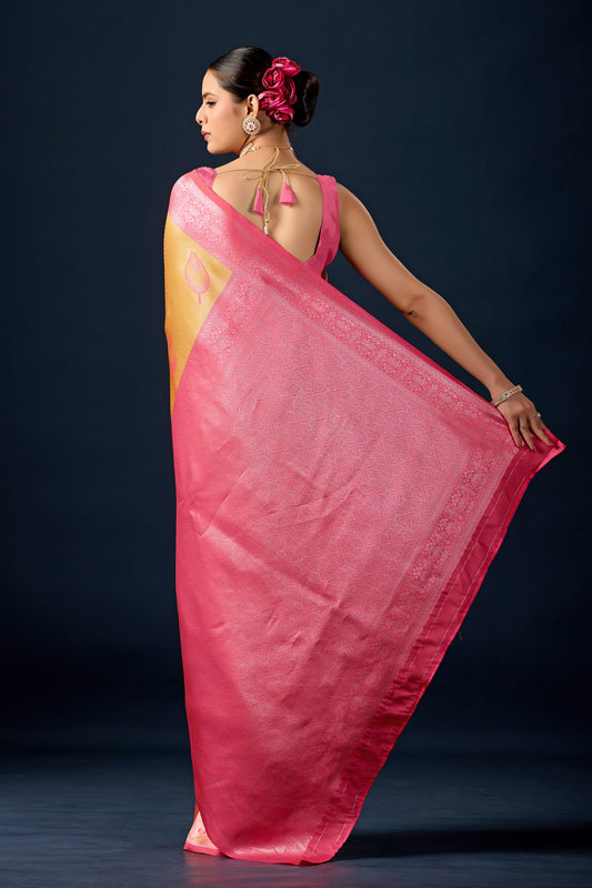 Woman draping mustard gold dark pink leaf motif zari pallu silk saree showing pallu design — Chandrikas