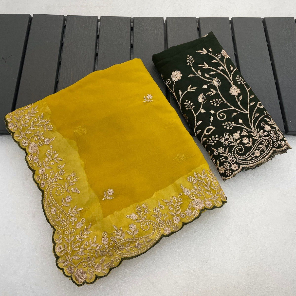 Mustard yellow Georgette saree flatlay with floral embroidered border and matching blouse — Chandrikas