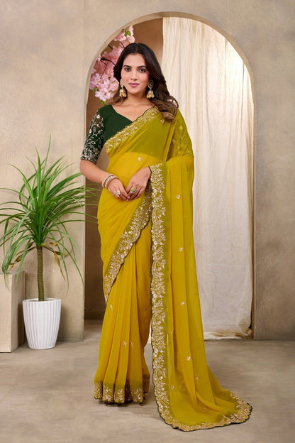 Woman wearing a mustard yellow Georgette saree with floral embroidered border and blouse — Chandrikas