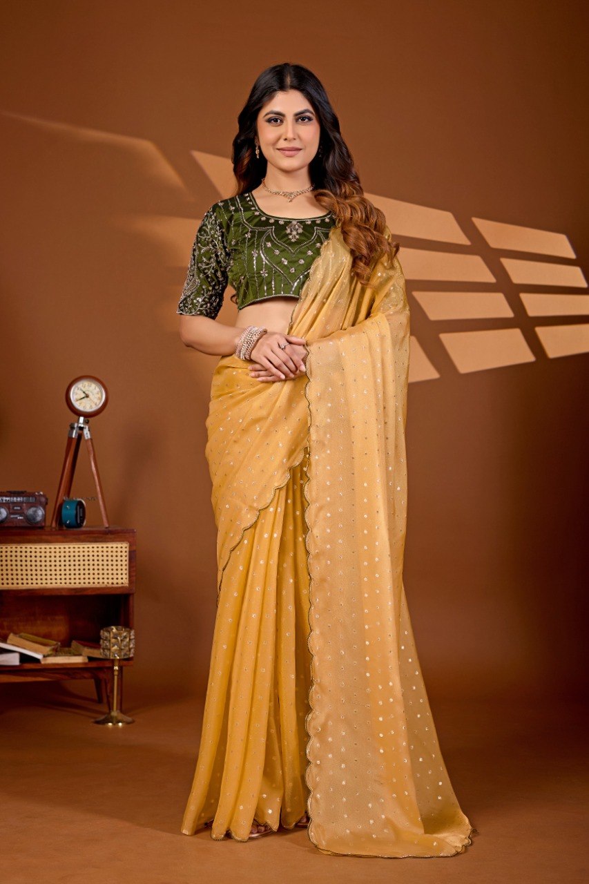 Woman wearing a mustard yellow sequin work chiffon silk saree with green embroidered blouse — Chandrikas