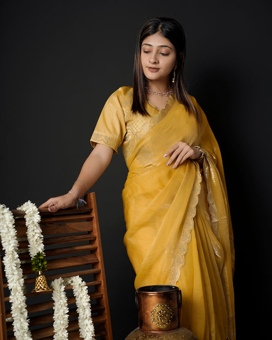 Woman in front pose wearing mustard yellow tissue crepe silk saree with scalloped border — Chandrikas