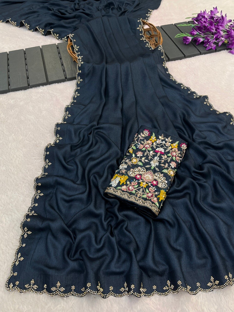 Navy blue Tesla saree flatlay with floral embroidered border and matching blouse — Chandrikas