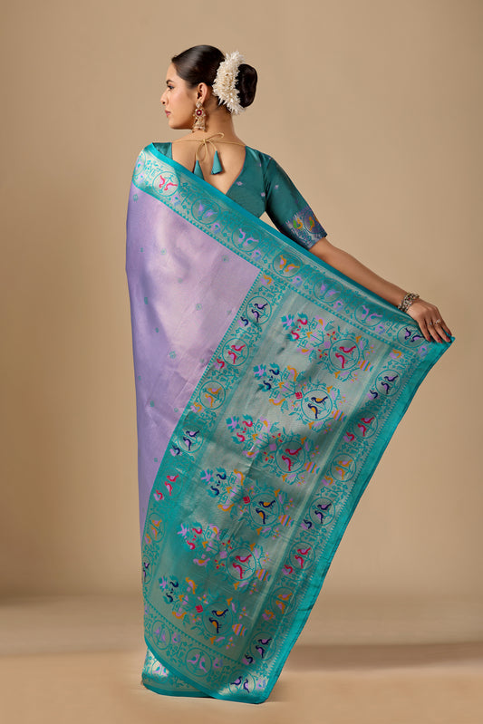 Woman draping pastel lavender Paithani silk bird border pallu saree showing bird motif — Chandrikas
