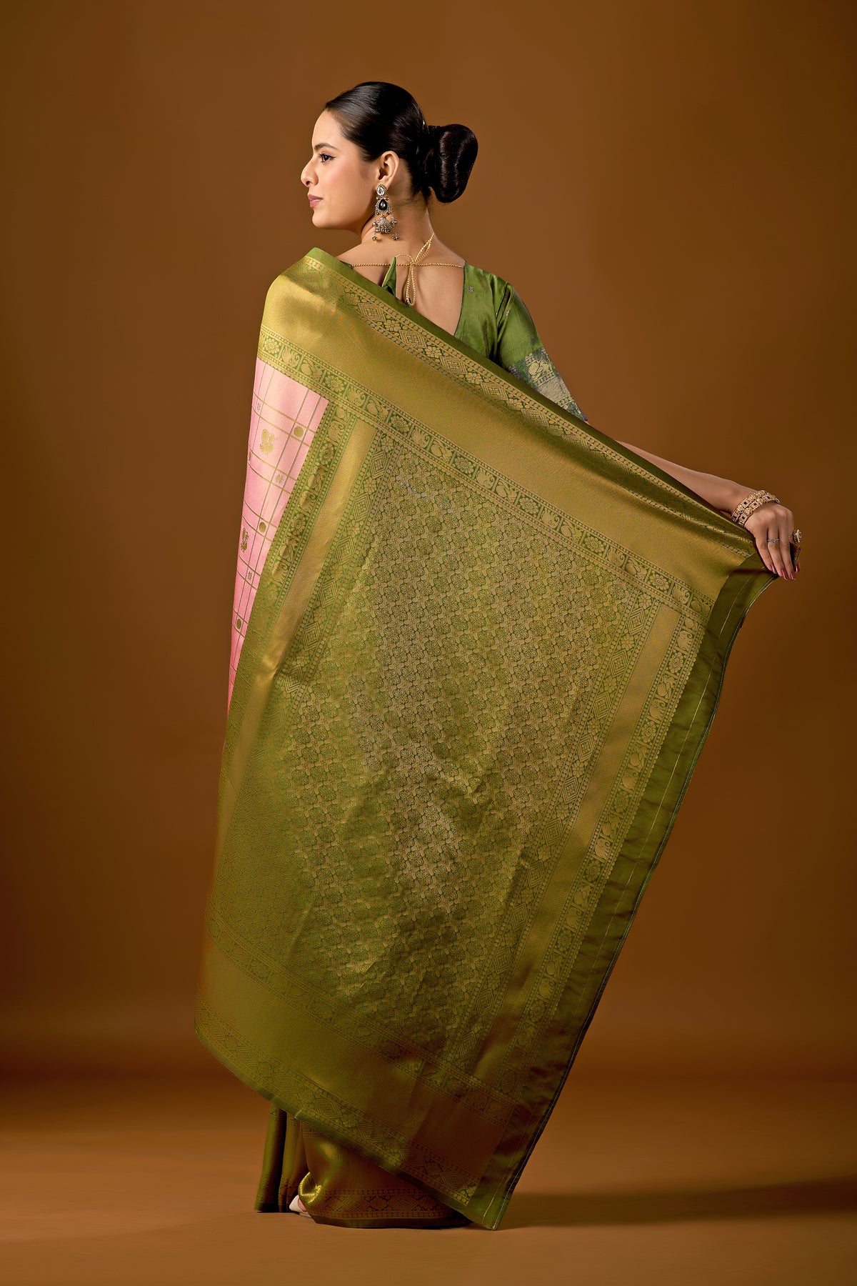 Woman draping pastel pink olive green Banarasi silk checks pattern saree showing pallu design — Chandrikas
