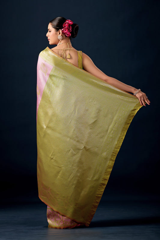 Woman draping pastel pink olive green leaf motif zari pallu silk saree showing pallu design — Chandrikas