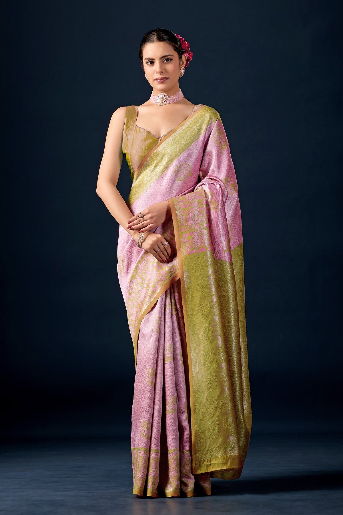 Woman in front pose wearing pastel pink olive green leaf motif zari pallu silk saree — Chandrikas