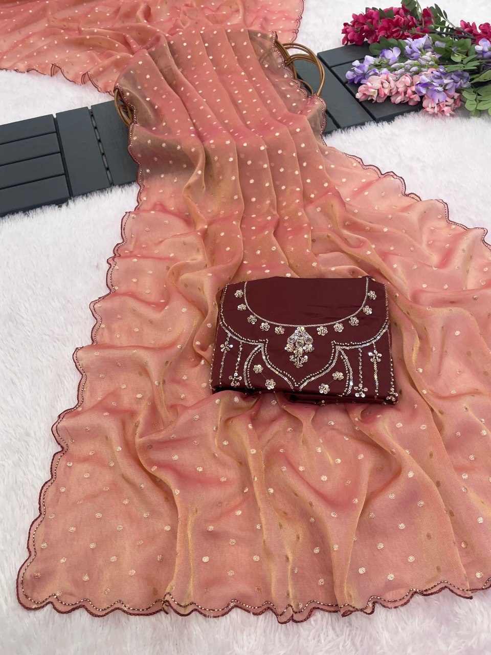 Peach coral sequin work chiffon silk saree flatlay with embroidered clutch — Chandrikas