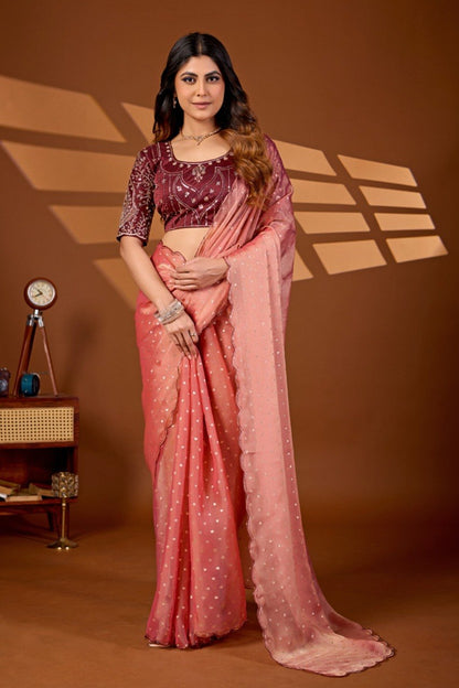 Woman wearing a peach coral sequin work chiffon silk saree with embroidered blouse — Chandrikas