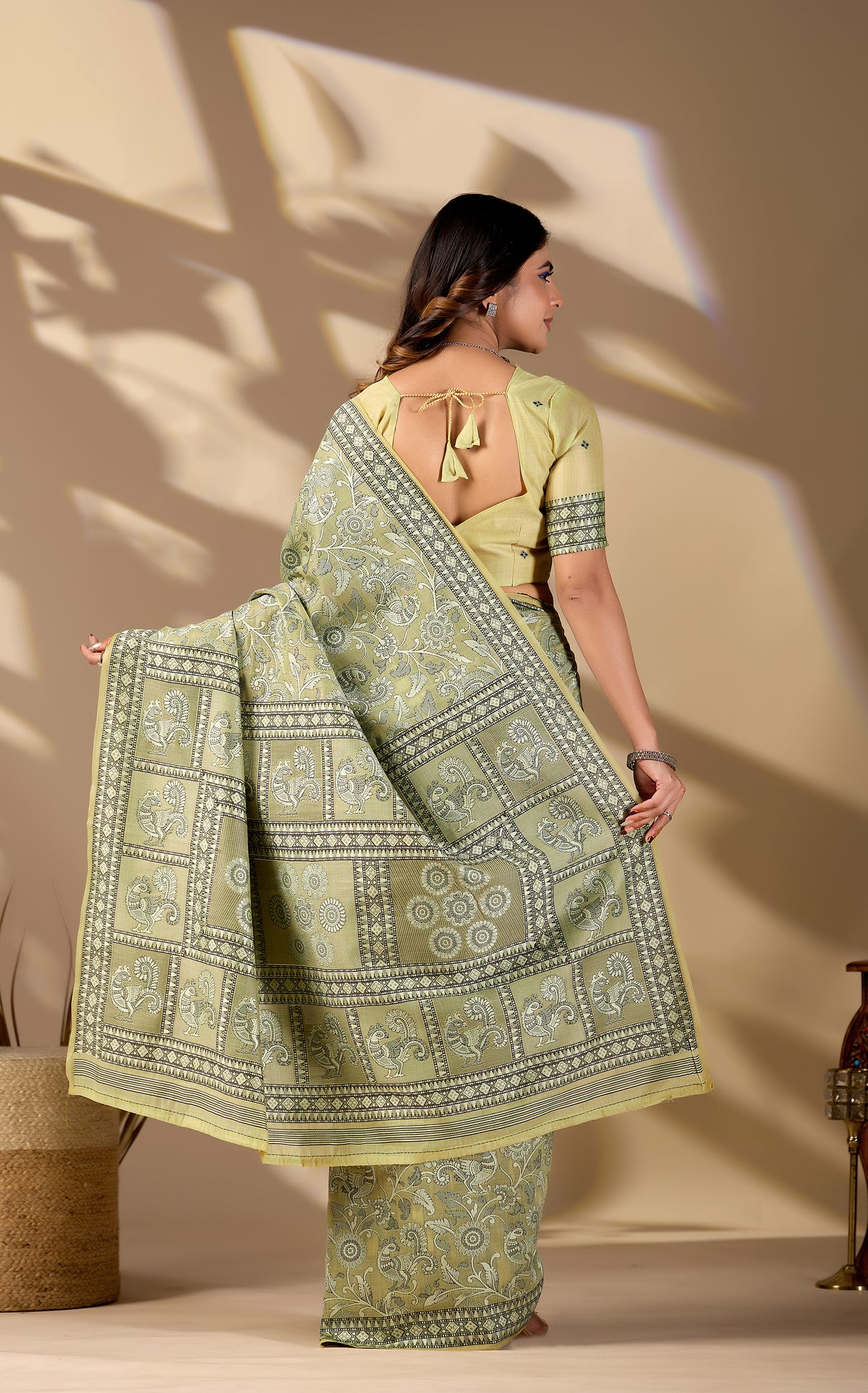 Woman draping pista green Banarasi cotton jacquard jaal saree showing pallu motif — Chandrikas