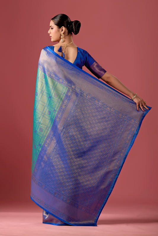Woman draping rama green dark blue Banarasi silk checks pattern saree showing pallu design — Chandrikas