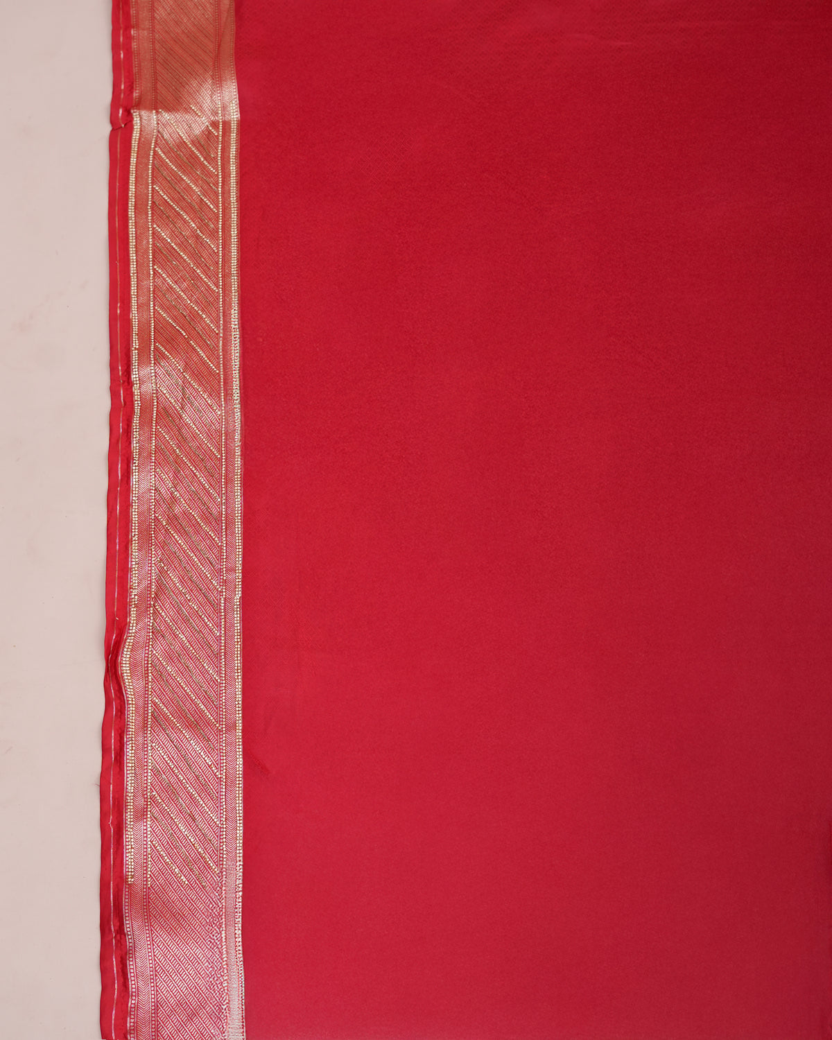 Close-up of red Banarasi silk matching blouse piece fabric edge — Chandrikas