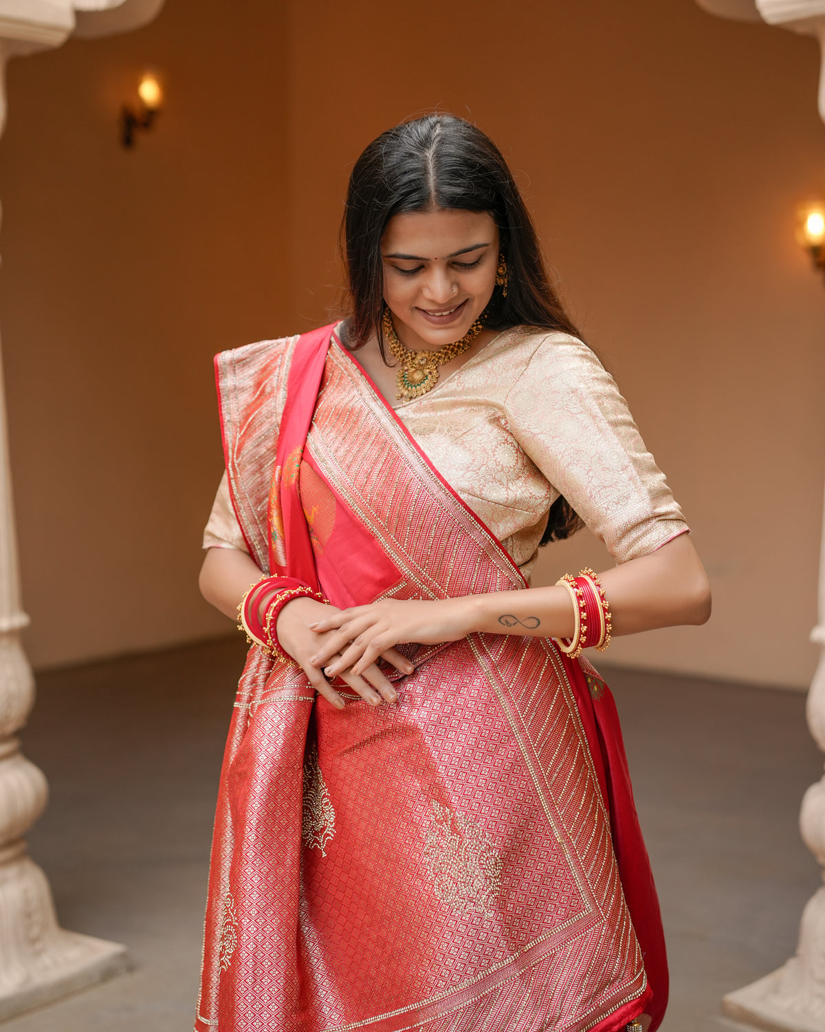Woman in close pose wearing red Banarasi silk Jharkan work diamond jaal saree — Chandrikas