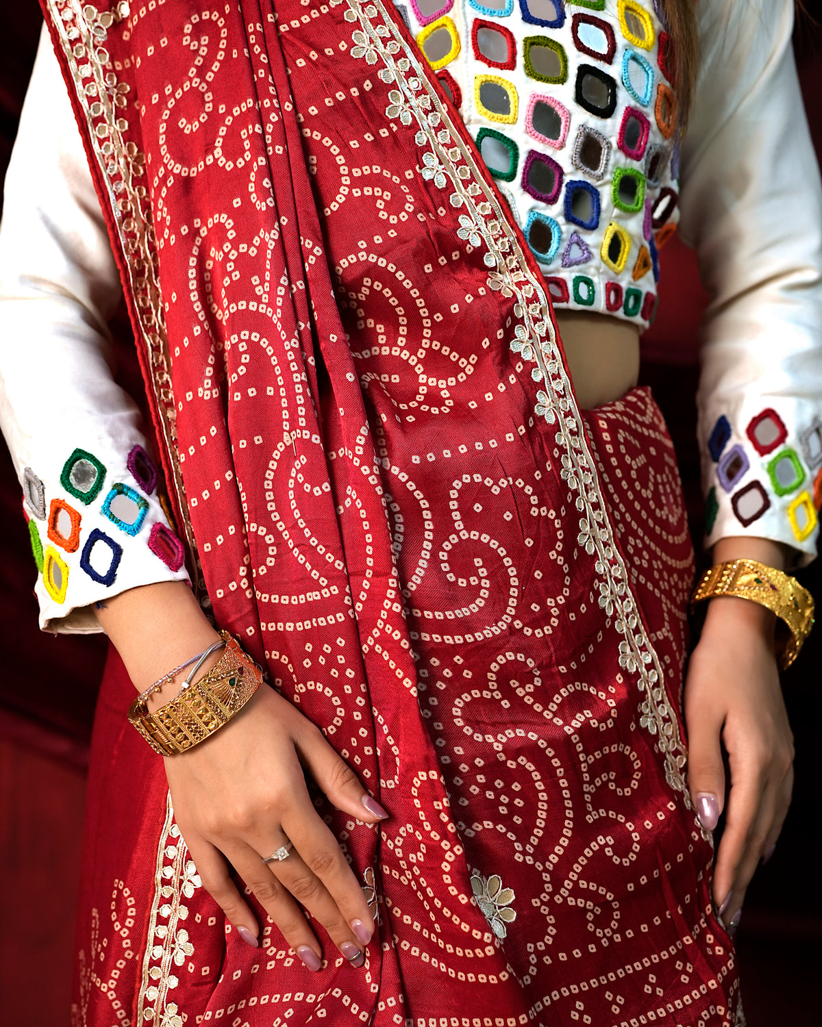 Close-up of red Bandhani saree blouse with Gota Patti embroidery detail — Chandrikas