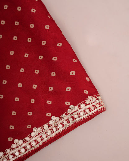 Folded red Bandhani saree fabric showing bandhani print and gota patti border — Chandrikas