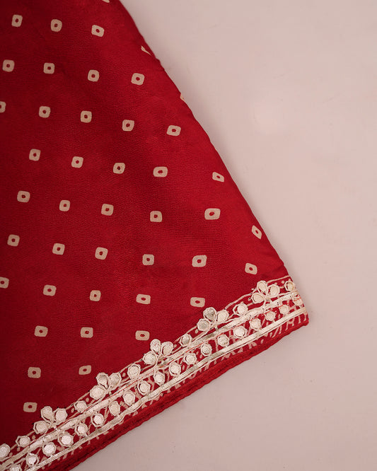 Folded red Bandhani saree fabric showing bandhani print and gota patti border — Chandrikas