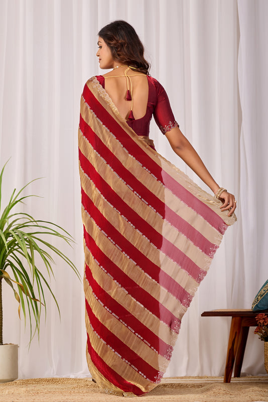 Woman in back pose wearing red striped satin patta saree with golden border — Chandrikas