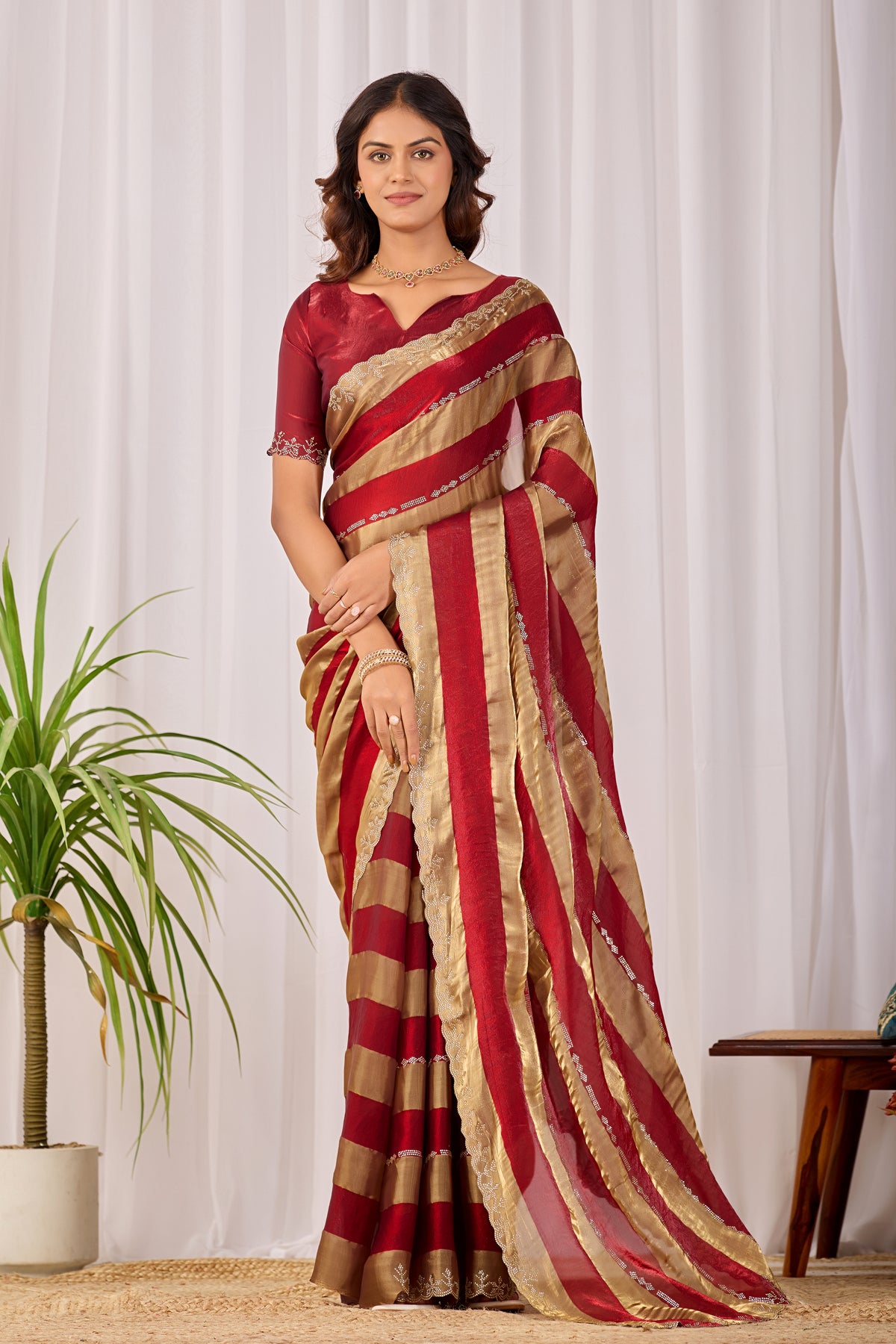 Woman in front pose wearing red striped satin patta saree with golden border — Chandrikas
