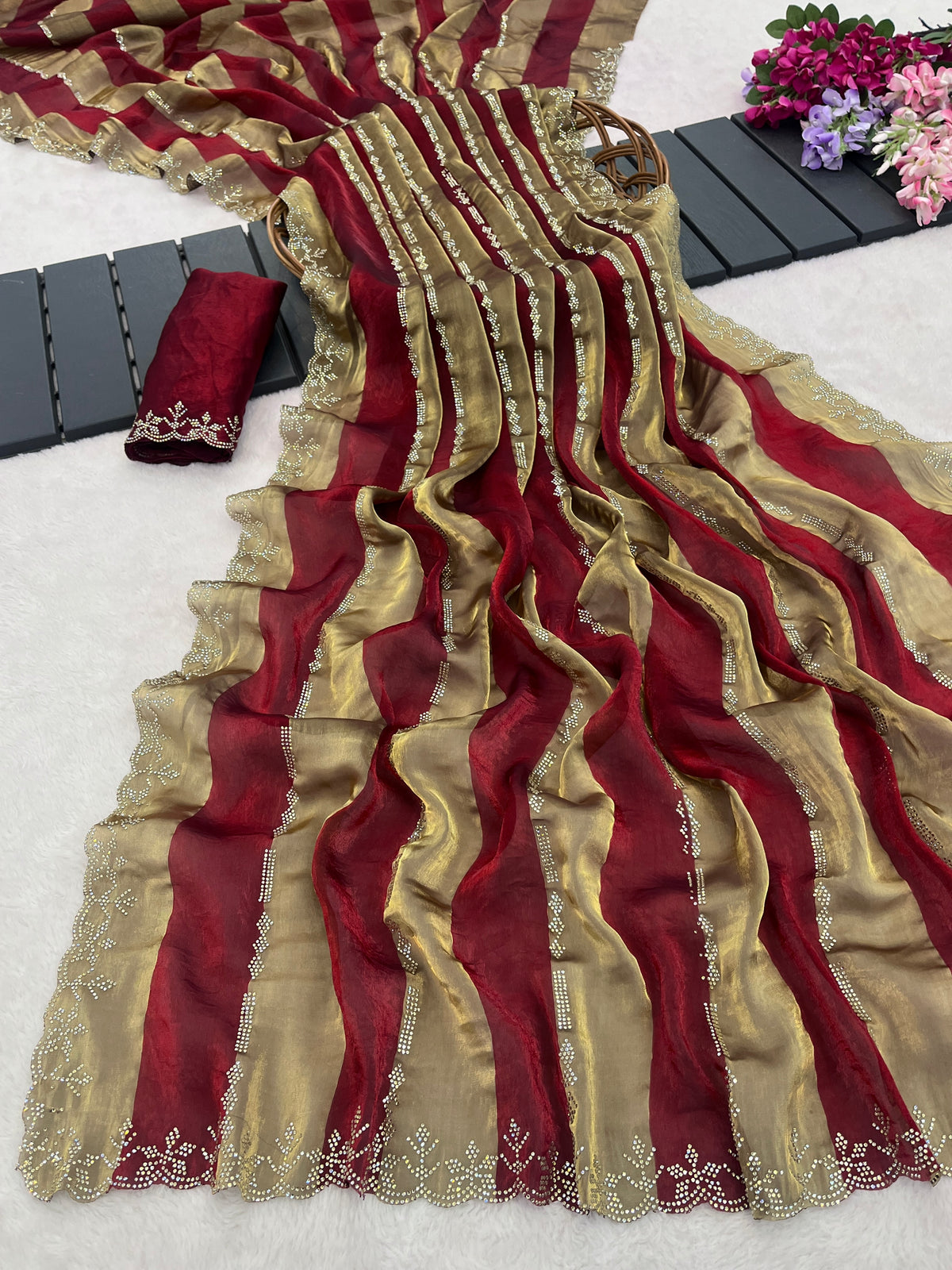 Woman in side pose wearing red striped satin patta saree with golden border — Chandrikas