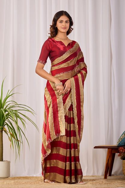 Woman in standing pose wearing red striped satin patta saree with golden border — Chandrikas
