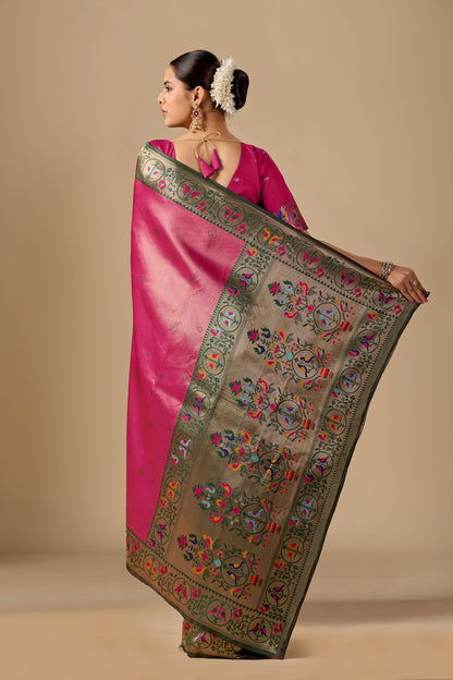 Woman draping rose pink Paithani silk bird border pallu saree showing bird motif — Chandrikas