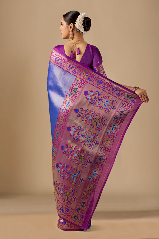 Woman draping royal blue Paithani silk bird border pallu saree showing bird motif — Chandrikas