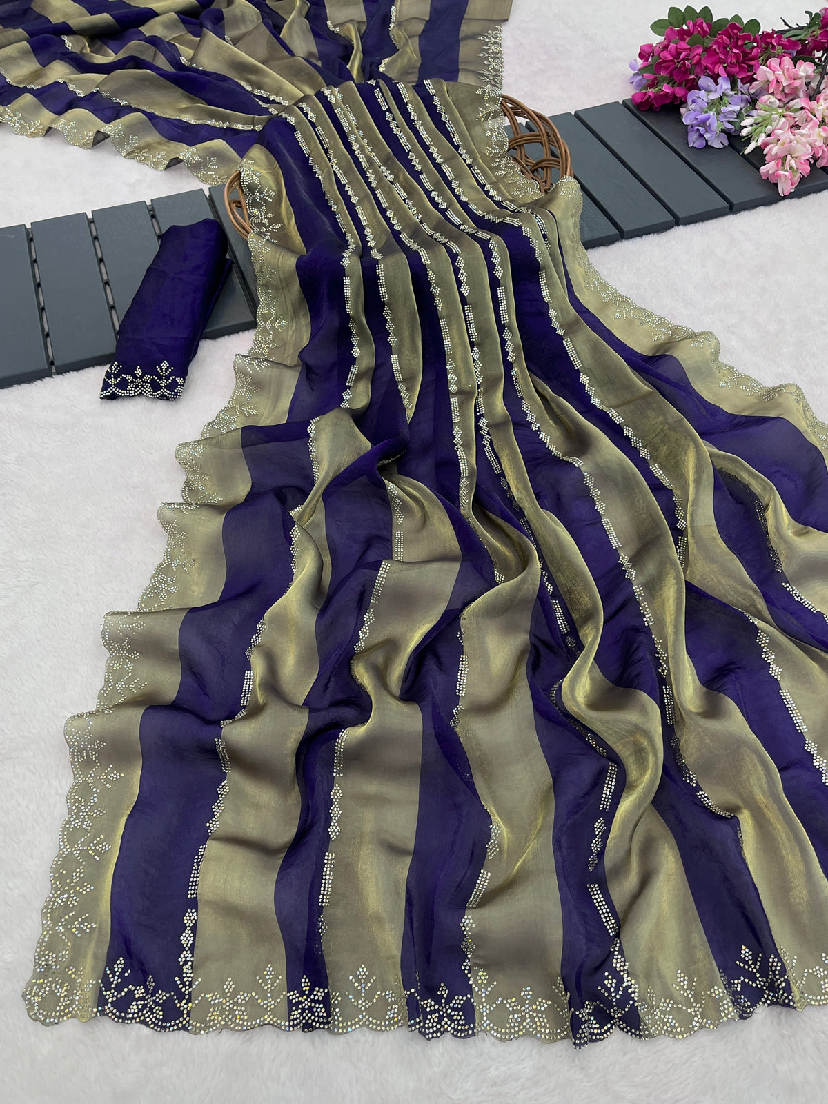 Woman in side pose wearing royal purple striped satin patta saree with golden border — Chandrikas