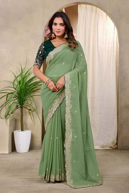Woman wearing a sage green Georgette saree with floral embroidered border and blouse — Chandrikas
