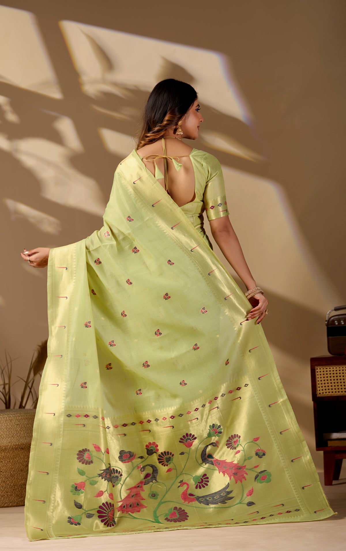 Woman draping sea green Banarasi-Paithani zari pallu cotton saree showing peacock motif — Chandrikas