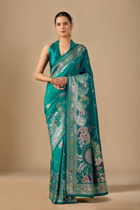 Woman in front pose wearing sea green Meenakari deer motif zari pallu silk saree — Chandrikas