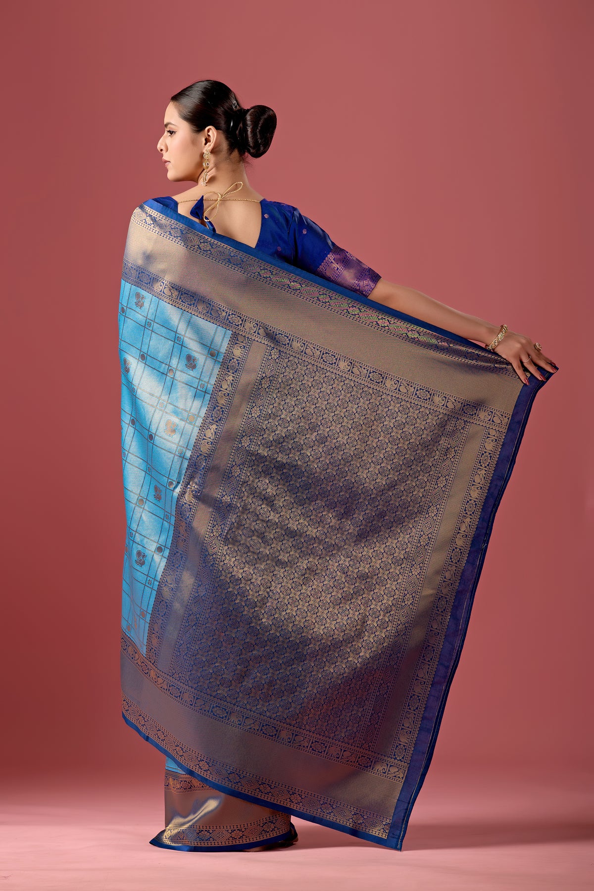 Woman draping sky blue grey Banarasi silk checks pattern saree showing pallu design — Chandrikas