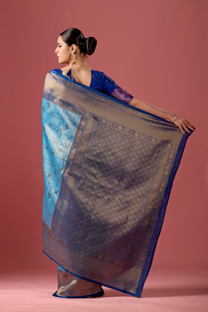 Woman draping sky blue grey Banarasi silk checks pattern saree showing pallu design — Chandrikas