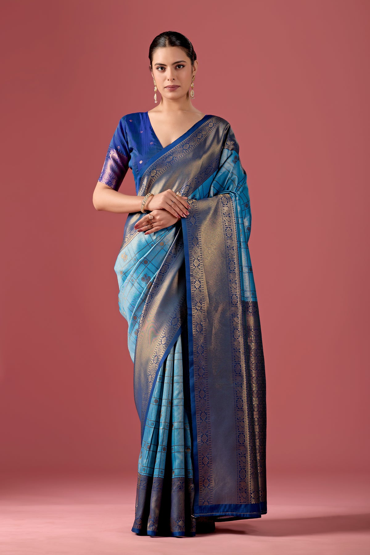 Woman in front pose wearing sky blue grey Banarasi silk checks pattern saree — Chandrikas
