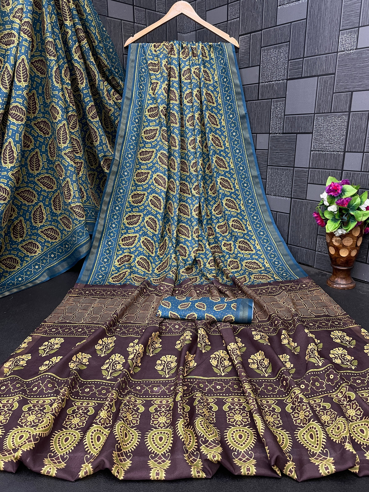 Teal blue leaf print cotton saree flatlay with brown border and matching blouse — Chandrikas