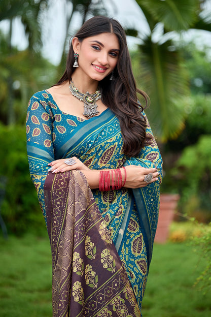 Woman in close pose wearing teal blue leaf print cotton saree with brown border — Chandrikas