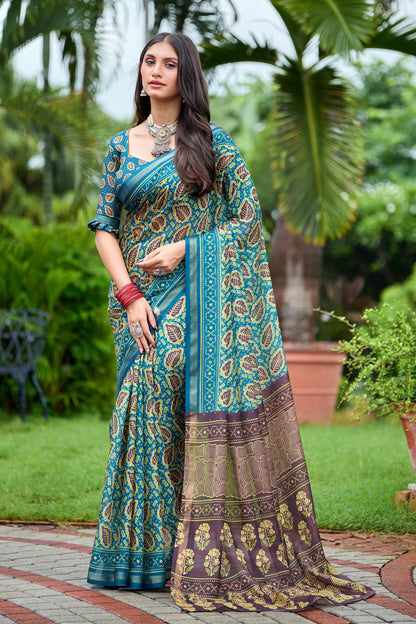Woman in standing pose wearing teal blue leaf print cotton saree with brown pallu — Chandrikas