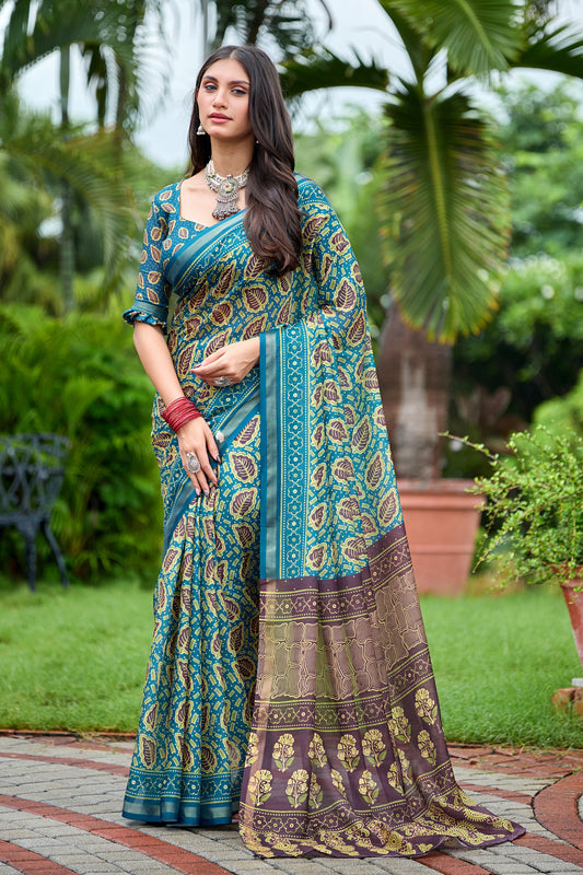 Woman in standing pose wearing teal blue leaf print cotton saree with brown pallu — Chandrikas