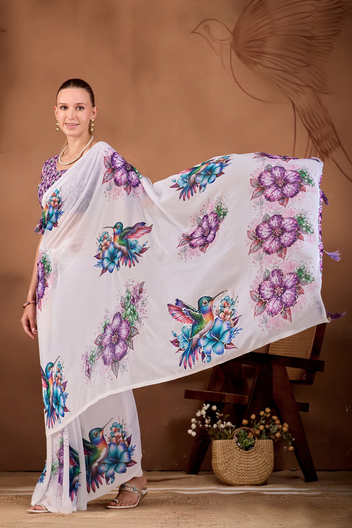 Model holding the pallu of White Jamli floral bird printed weightless saree to show floral and bird print — Chandrikas