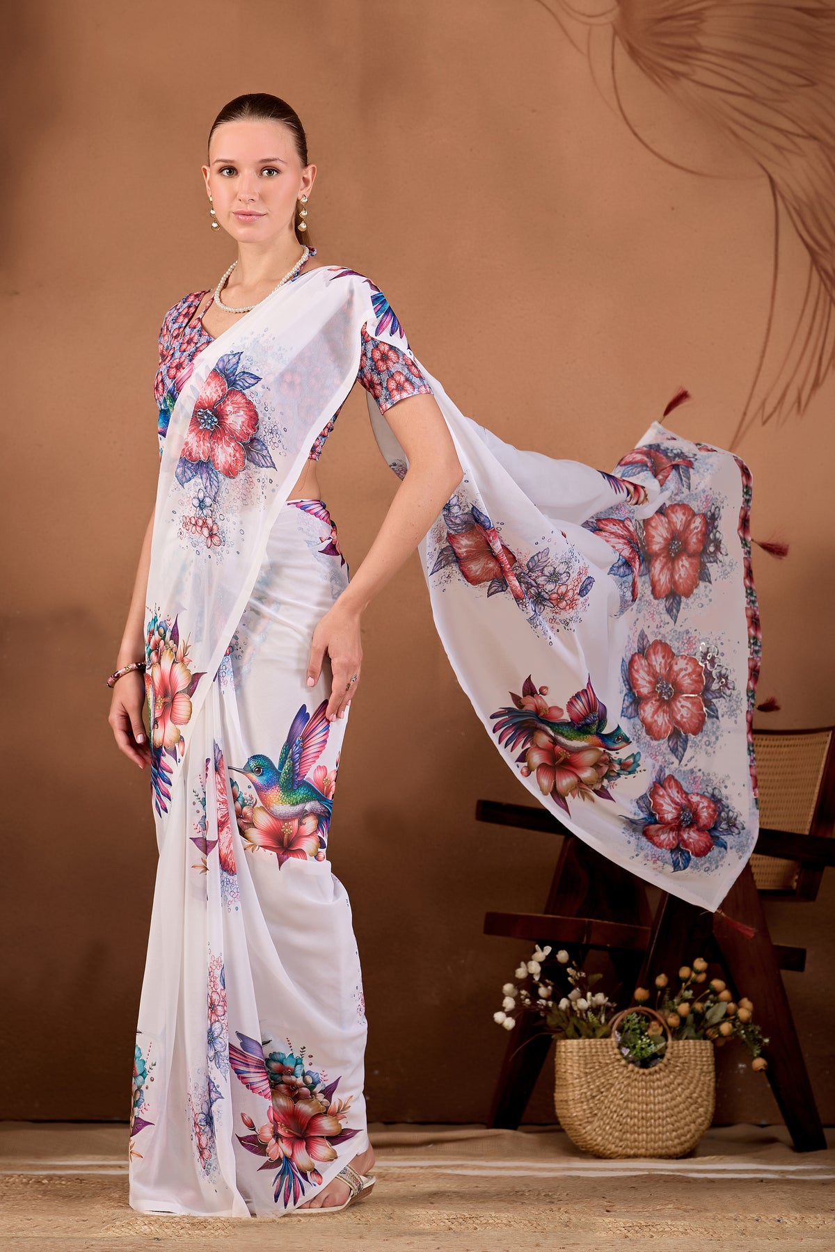 Model lifting the pallu of White Maroon floral bird printed weightless saree to show full floral and bird print — Chandrikas
