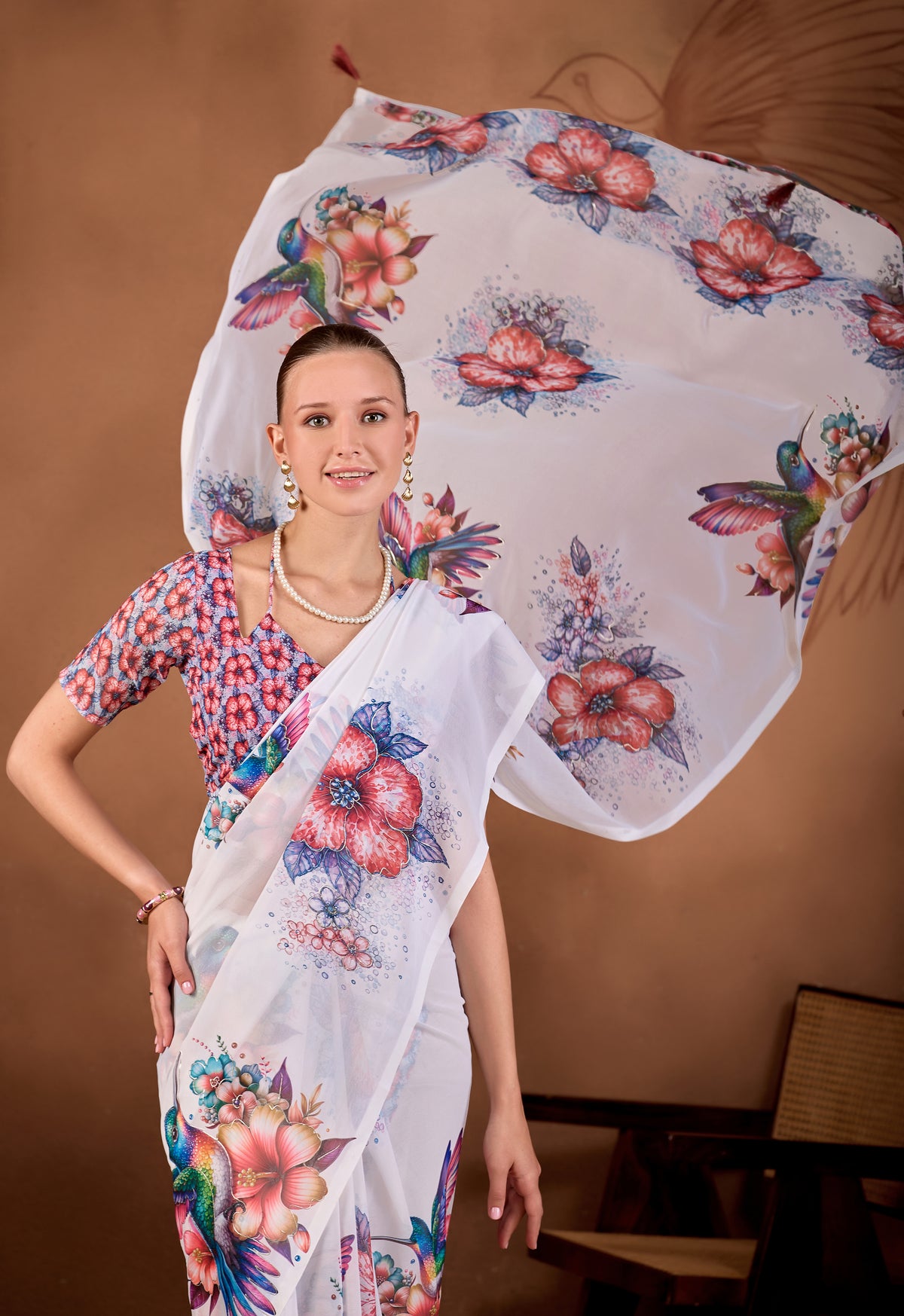 Model holding the pallu of White Maroon floral bird printed weightless saree to show floral and bird print — Chandrikas