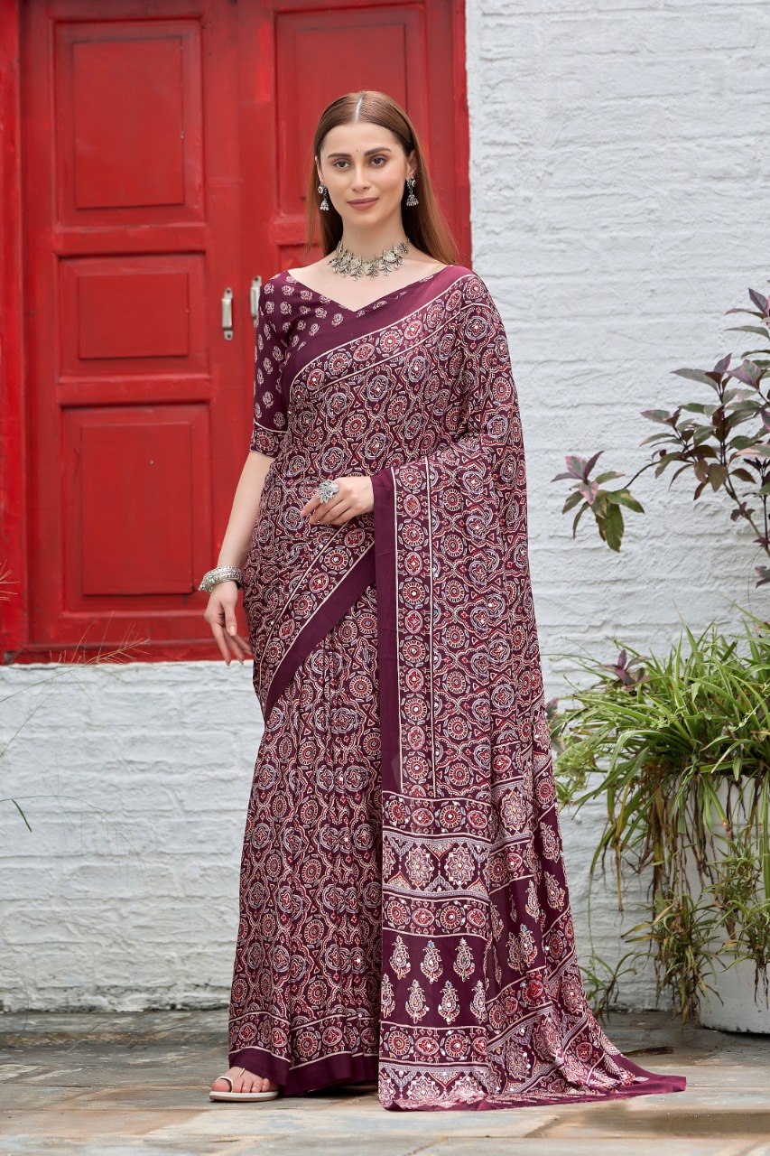 Woman wearing a wine deep maroon Ajrakh print mirror work Italian crepe saree with matching blouse — Chandrikas